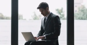 young man typing in his laptop and searching for best jobs for introverts