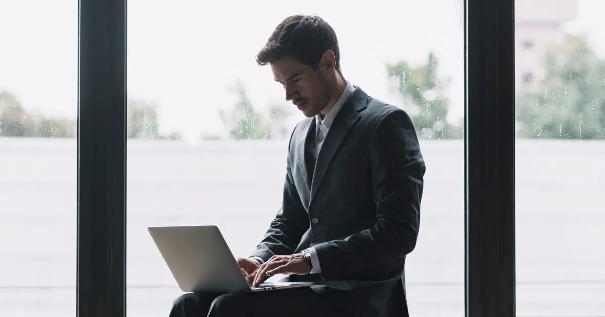 young man typing in his laptop and searching for best jobs for introverts